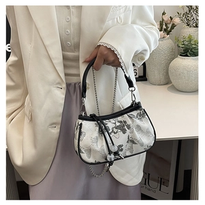 Detailed view of women's tote with traditional Chinese pine and crane embroidery pattern