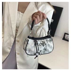 Detail of embroidered small square bag with Chinese landscape pattern and silver chain strap