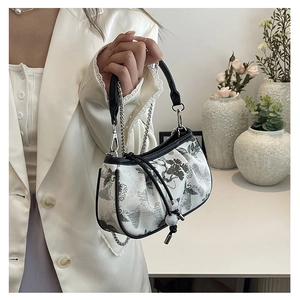 Detail view of New Chinese style handbag with ink painting pattern and tassel chain