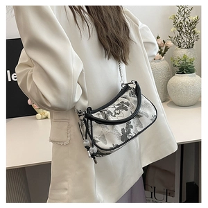 Detail of elegant cloud-shaped bag with traditional ink painting and metal chain