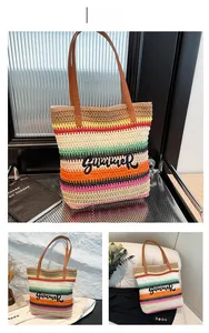 Close-up of colorful striped straw tote bag featuring embroidered SUMMER text and brown straps