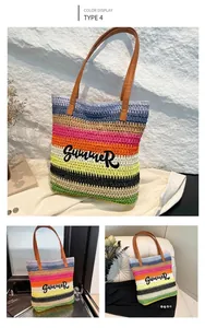 Detail of colorful striped straw tote bag featuring black Summer embroidery and leather handles