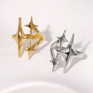 Minimalist gold and silver star stainless steel open rings for women on white surface
