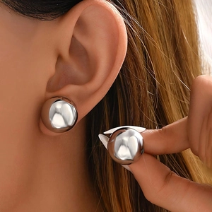 Modern oversized metallic sphere earrings for women with a polished silver finish