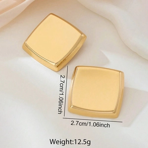 Vintage style square gold earrings with high-polish metallic finish on silk fabric