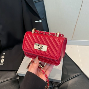 Mini red quilted leather crossbody bag with V-shaped stitching and golden chain strap