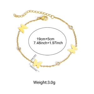 Gold butterfly stainless steel bracelet with zircon crystals on a plain white background