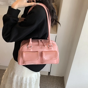 Glossy pink underarm bag with double front pockets and retro shoulder strap design