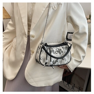 Detail of embroidered mini handbag with ink wash pine print and metal chain strap