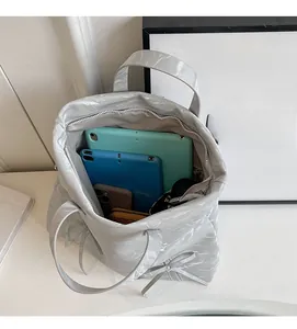 Interior view showing the large storage capacity of this silver-gray PU crossbody bag
