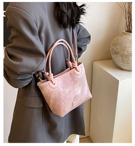 Close-up of pink fashion & bags bucket bag with textured finish and adjustable strap