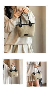 Close-up of beige textured handbag with black handles and fashion & bags label detail