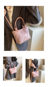 Close-up of pink marbled bucket bag with circular handles and elegant metal logo detail