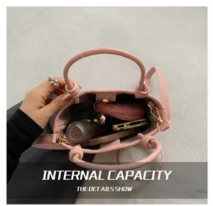 Detail view of pink bucket bag interior showing capacity for phone and accessories