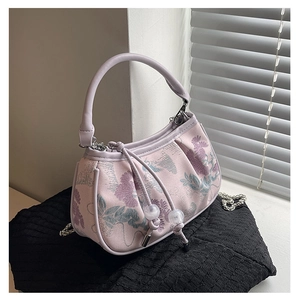 Detail of lavender jacquard embroidery handbag with floral patterns and silver chain