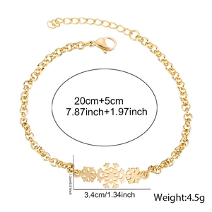 Detail view of 18K gold plated stainless steel bracelet featuring three snowflake pendants