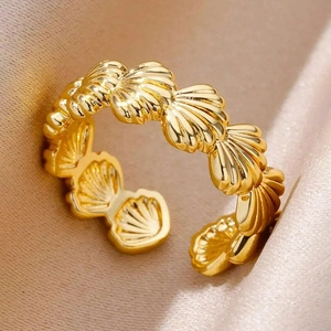 18K gold-plated shell-shaped open ring made of stainless steel for women on silk background