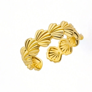 Detailed view of gold scallop shell ring with adjustable open band and polished finish