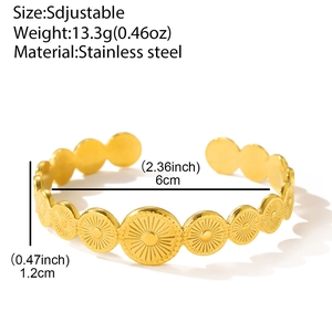Macro detail of gold stainless steel spring cuff with radial sunburst texture and dimensions