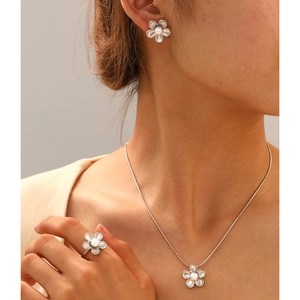 Elegant stainless steel floral jewelry set with white pearls for women on model
