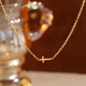 Polished gold stainless steel cross necklace for women with a minimalist pendant