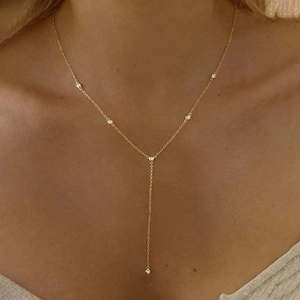 Elegant 18K gold Y-shaped Lariat necklace with zircon pendants on a model's neckline