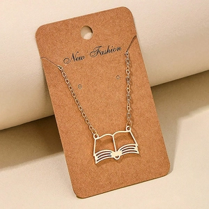 Minimalist golden stainless steel book pendant necklace displayed on a kraft jewelry card