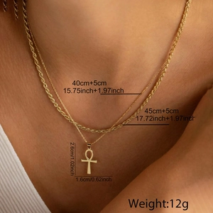 Close-up of golden layered Ankh cross necklace set with detailed size measurements
