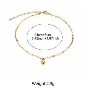 Detail view of gold minimalist anklet with a polished bead charm and lobster clasp
