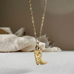 Golden stainless steel necklace with cowboy boot pendant featuring western star details