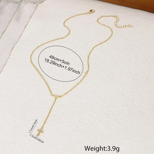 Detail view of gold cross heart necklace showing chain length and pendant size dimensions
