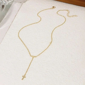 Detail of gold Y-shaped necklace with double cross pendants and adjustable chain