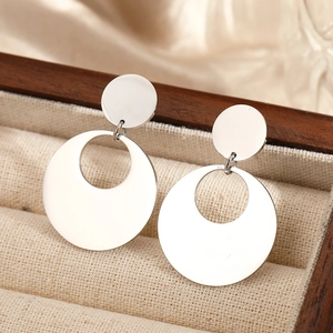 Minimalist silver geometric round drop earrings in a luxury linen jewelry display box