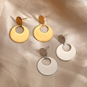 Minimalist geometric circular earrings in gold and silver finish on champagne silk