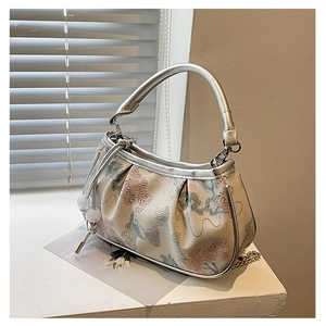 Close-up of vintage mini tote bag with pink floral embroidery and silver chain strap