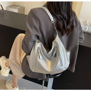 Detail of silver metallic hobo bag with vintage crinkled texture and dual front zippers