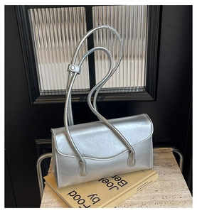 Close-up of metallic silver PU leather handbag with sleek flap and thin straps
