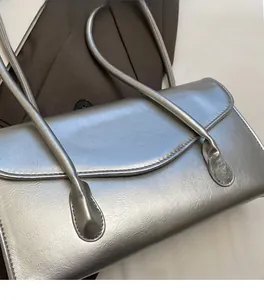 Close-up of silver PU leather handbag showing crumpled texture and metallic finish