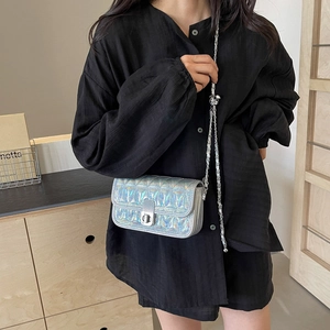 Quilted silver holographic crossbody bag with metal chain strap and turn-lock closure