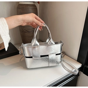 Detail of silver woven PU handbag with dual handles and slim adjustable shoulder strap