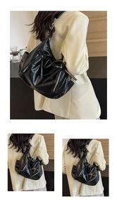 Detail view of black lychee texture bucket bag featuring bow decor and metal zipper
