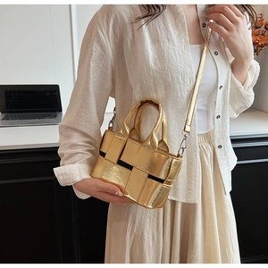Detail of mini gold woven tote bag featuring high-quality metallic finish and crossbody strap