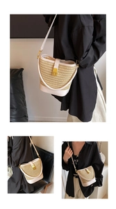 Detail of woven bucket bag with beige straw texture, white leather trim and gold metal clasp