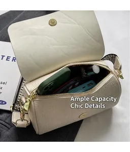 Macro view of beige barrel bag with zipper closure and interior storage space