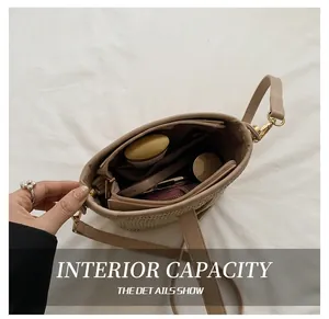 Top view of the woven bucket bag interior showing daily items and zip pocket