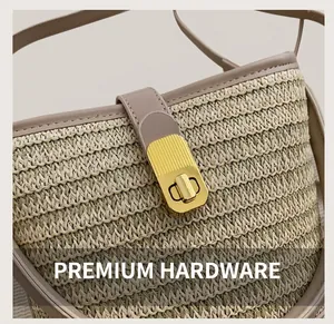 Detailed macro view of woven straw bag featuring gold-toned striped rotating metal clasp
