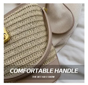 Detail showing woven straw texture with beige leather trim and gold metal buckles
