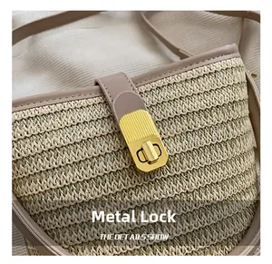 Detailed macro of golden metal clasp and woven texture on beige straw bucket bag