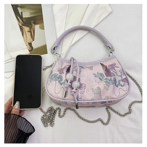 Detail of lavender embroidery on a handbag with silver chain and bead drawstring decor
