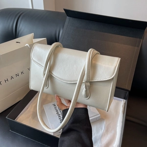 Chic cream white shoulder bag with slim straps and a sophisticated faux leather texture